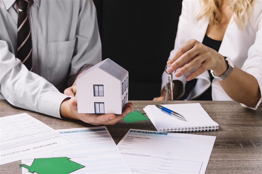 Real estate agent handing over keys